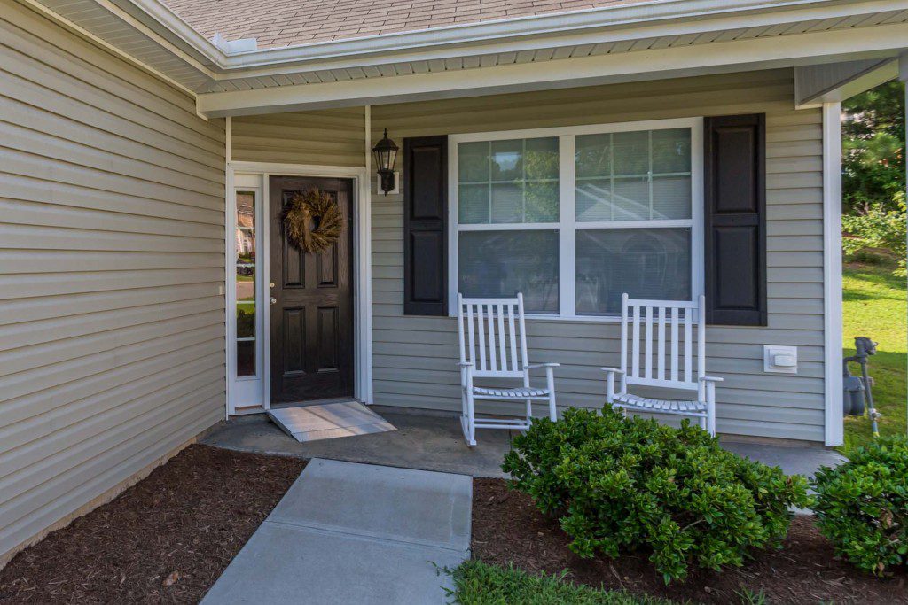Covered front porch with two white rocking chairs at Avendelle at Lazy River